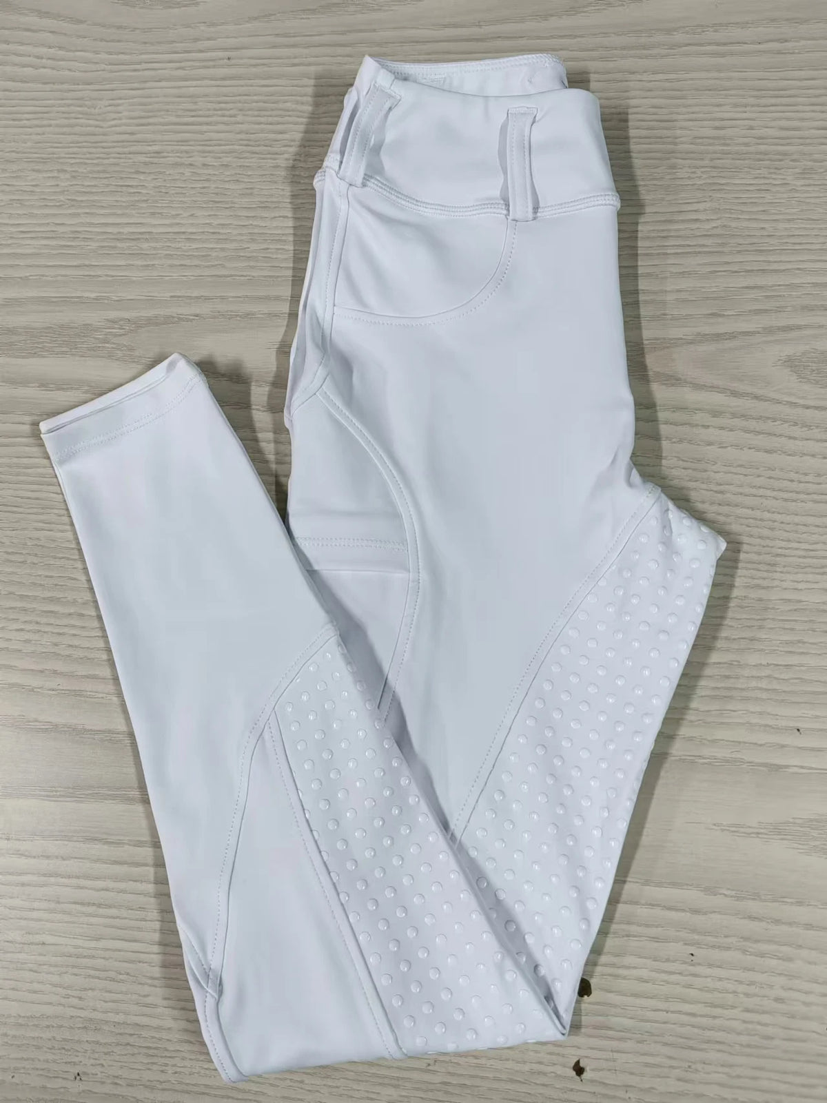 White women's horse riding breeches shown flat